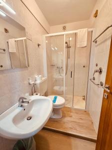 a bathroom with a sink and a toilet and a shower at Hotel Playa in Bibione +16 photos