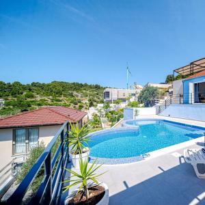 a swimming pool on the side of a house at Villa Love house in Vela Luka