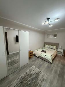 a bedroom with a bed and a sliding glass door at Sofia Apartment in Galaţi