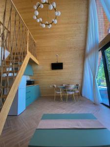 a kitchen and dining room with a staircase and a table at Cozy Cottage Martvili in Martvili