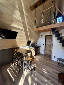 a kitchen with a table and chairs in a room at Tiny house au coeur de la nature in Touët-sur-Var