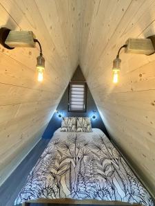 a bed in a tiny house with lights on it at Tiny house au coeur de la nature in Touët-sur-Var