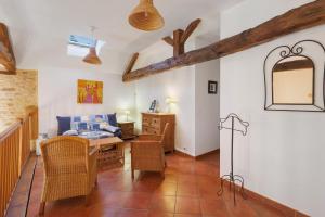 a room with a desk and a table and chairs at Maison de vacances Le Tilleul in Saint-Pompont