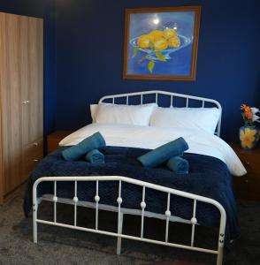 a bedroom with a bed with a blue wall at Peake Edge Home in Chesterfield