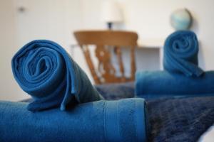 two blue towels on top of a bed at Peake Edge Home in Chesterfield