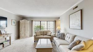 a living room with a couch and a table at Ocean Block retreat with easy beach access & shared pools in Ocean City