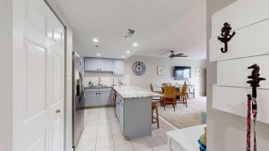 a kitchen with white appliances and a dining room at Ocean Block retreat with easy beach access & shared pools in Ocean City