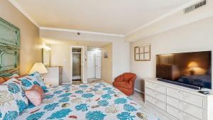 a bedroom with a bed and a flat screen tv at Ocean Block retreat with easy beach access & shared pools in Ocean City +30 photos