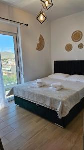a bedroom with a large bed and a large window at Anastasia Karystos in Karistos