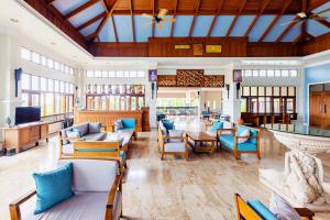 a lobby with couches and chairs and a bar at The Fair House Beach Resort & Hotel in Chaweng Noi Beach