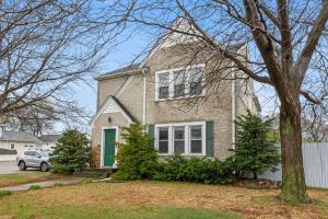 a large brick house with a green door at Main Street Suite in Anoka