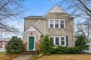 a brick house with a green door at Main Street Suite in Anoka