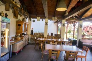 a restaurant with tables and chairs in a room at Penzion U Bohuša in Lednice