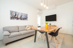 a living room with a table and a couch at Domus Luxi in Teulada