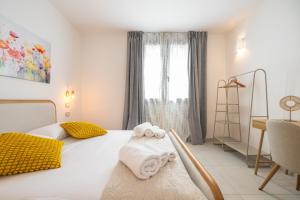 a bedroom with a bed with towels on it at Domus Soli in Teulada
