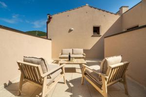 two chairs and a table on a patio at Domus Soli in Teulada