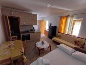 a living room with a couch and a table at Cozy Apartment in Drymades Village in Dhërmi