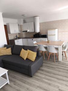 a living room with a couch and a table at Sea, Sun and Wild Nature in Costa de Santo André