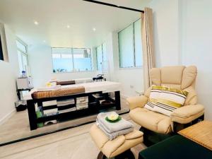 a living room with a chair and a mirror at Chalet 23 Widemouth Bay in Bude +19 photos
