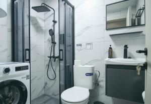 a bathroom with a shower and a toilet and a sink at RiverSide Apartments in Veles +22 photos