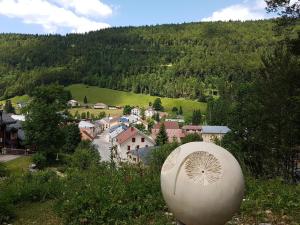 a view of a small town in a mountain at La Louvatière 28 in Mijoux +5 photos