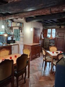 a kitchen with tables and chairs in a room at Attic with balcony at Locanda del Capo in Capannori