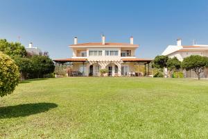a large house with a large lawn in front of it at Villa Nefeli Akti Salonikiou B in Ayios Nikolaos Sithonia