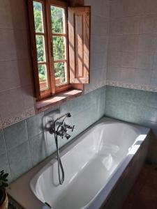 a bath tub with a faucet in a bathroom at Attic with balcony at Locanda del Capo in Capannori +62 photos