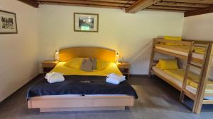 a bedroom with a bed and two bunk beds at Der Perweinhof in Donnersbachwald