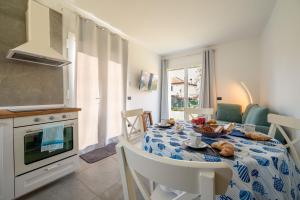 a kitchen with a table with a plate of food on it at I LAGHEE casette BREVA e TIVANO Lakeside Garden Bike&Boat&Scooter Lake Como in Colico