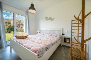 a bedroom with a bed and a large window at I LAGHEE casette BREVA e TIVANO Lakeside Garden Bike&Boat&Scooter Lake Como in Colico