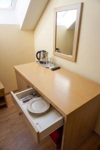a counter in a room with a sink and a mirror at Penzion U Bohuša in Lednice +43 photos
