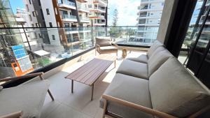 a balcony with a couch and a table on a building at Spacious & Modern - Best Larnaca Location in Larnaca