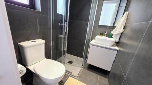 a bathroom with a white toilet and a shower at Spacious & Modern - Best Larnaca Location in Larnaca +14 photos