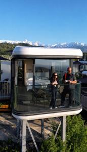 two people standing inside of a tiny house at Sunny Home Park in Almaty +47 photos