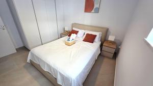 a bedroom with a bed with a box of tissues on it at Spacious & Modern - Best Larnaca Location in Larnaca
