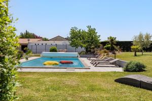 a swimming pool with two pillows in a yard at Chambre d'Hote Familiale in Neuville-du-Poitou
