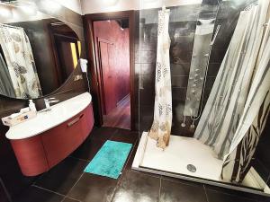 a bathroom with a shower and a sink and a shower at Suite Rosso 24 in Iesi +8 photos