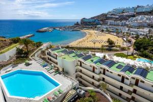 an aerial view of a resort and a beach at Modern Sea View Apartment Near Beach & Pool Puerto Rico in Puerto Rico de Gran Canaria