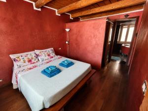 a bedroom with a bed with two blue towels on it at Suite Rosso 24 in Iesi
