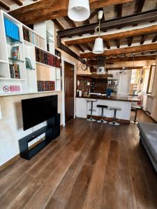 a living room with a large television and a table at Suite Rosso 24 in Iesi