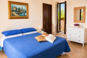a bedroom with a blue bed and a mirror at Villetta Incanto relax in Cava deʼ Tirreni