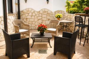 a patio with chairs and tables and a table with flowers at Villetta Incanto relax in Cava deʼ Tirreni