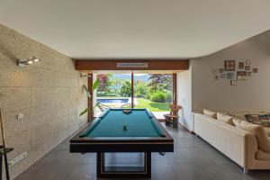 a pool table in the middle of a living room at Quinta Trindade in Arouca