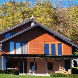 a house with orange and blue windows at Apartman Ružica in Banja