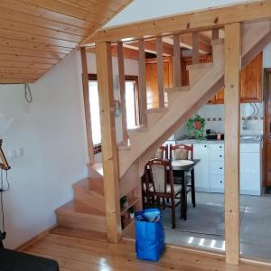 a staircase in a tiny house with a kitchen at Apartman Ružica in Banja +6 photos
