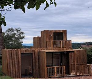 a wooden building with a deck on top of it at écolodge Calendula in Leimbach
