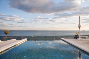 a swimming pool with a view of the water at Stella Maris in Podstrana
