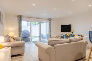 a living room with two couches and a tv at 2 Bed in Sandown oc-90013 in Sandown
