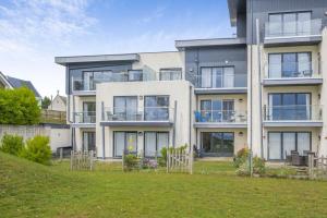 a large apartment building with a lawn in front of it at 2 Bed in Sandown oc-90013 in Sandown